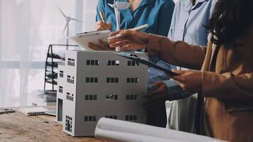 Three people working on a model of a building video
