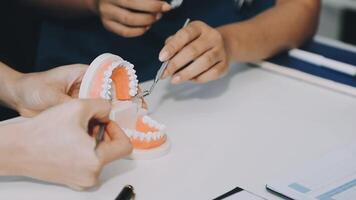 A person is cutting a tooth with a pair of scissors video