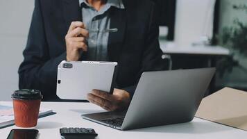 A man in a suit is holding a tablet computer video