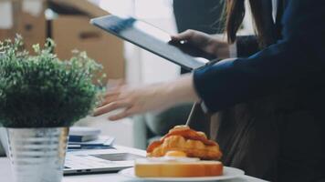 A person is using a tablet while sitting at a table video