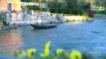 a boat is floating down a river next to a house video