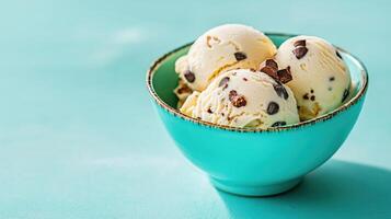Delicious vanilla ice cream with chocolate chips, served in turquoise bowl. refreshing treat photo