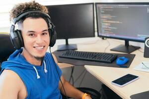 Portrait of a self-employed man working at home, looking at the camera smiling. photo