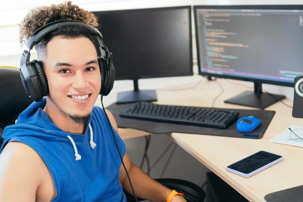 Portrait of a self-employed man working at home, looking at the camera smiling.