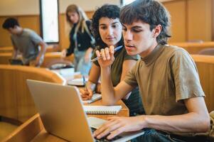 Students analyzing data on laptop during lesson photo
