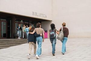 Anonymous friends walking in campus before studies photo