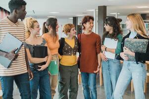 Diverse classmates meeting for studies in library photo