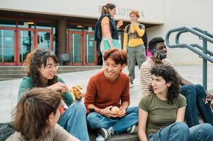 Diverse students resting on steps on street photo