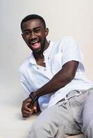 Optimistic black man laughing at camera photo