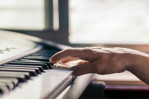 man playing piano with one hand. music keyboard photo
