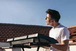 man playing a music keyboard and singing on a rooftop photo