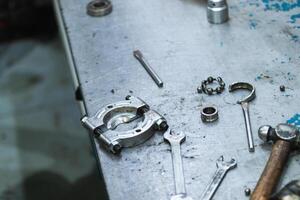 Various repair tools arranged on table in workshop photo