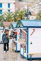 Christmas stalls at the fair with sweets, candies and drinks photo