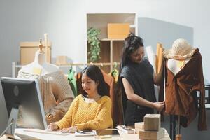 Two women working on a computer in a fashion store photo