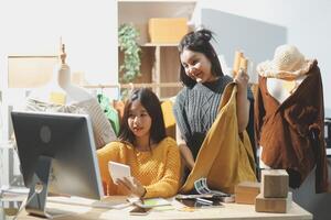 Two women are looking at a computer screen photo