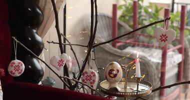 Discover the charm of Easter home decor with handmade decorations hanging from branches, creating a warm and inviting atmosphere for this festive season. video