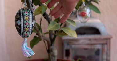Watch as handcrafted decorations come to life while making an Easter tree adorned with vibrant Easter pysanka. Transform your home with beautiful Easter decor that celebrates the season. video