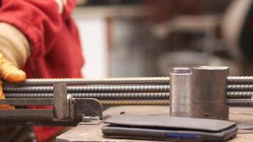 Craftsmen work with metal tools and materials at a busy workshop video