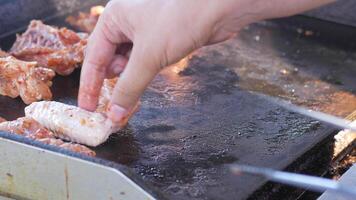 Grilling chicken on a hot griddle during the summer cookout video