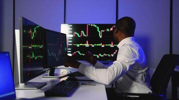 African American trader analyzing cryptocurrency market charts video
