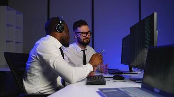 Two data center operators analyzing massive datasets video