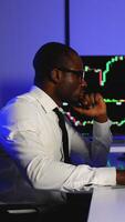 Stock trader analyzing market charts on multiple monitors video