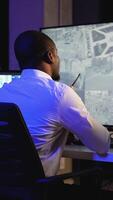 Security officer monitoring CCTV and giving instructions via walkie-talkie video