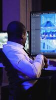Security officer monitoring CCTV and giving instructions via radio video