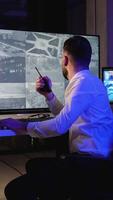 Security guard monitoring CCTV and talking on radio video
