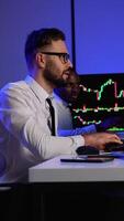 Two traders analyzing stock market data on multiple screens video
