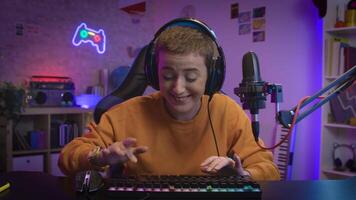 Excited happy Gamer Girl in Headset with Microphone Playing Online Game looking to camera POV video