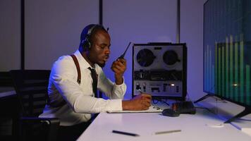 Intelligence officer monitoring intercepted audio and reporting video