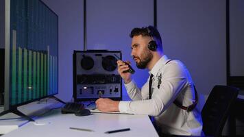 Intelligence officer monitoring intercepted audio and reporting video