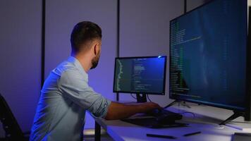 Cybersecurity analyst working on code and system monitoring video