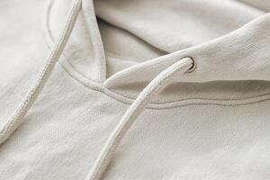 Neutral Hoodie Close-Up for E-Commerce Display Highlighting Drawstrings and Fabric Texture photo
