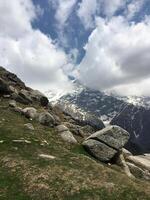 Scenic view of Dhauladhar range covered with snow and clouds. Overcast weather in the Indian Himalayas. Triund trek, Dharamsala, Himachal Pradesh, India. photo