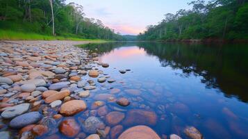 Twilight Reflection in River with Rocks and Trees photo