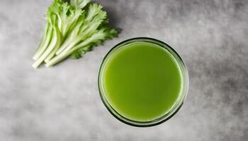 Overhead closeup of a glass of fresh celery juice photo