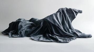 Abstract arrangement of draped gray fabric in soft natural light photo