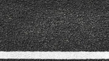 Close-up of asphalt road with single white line texture concept photo