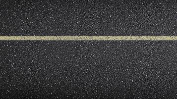 Yellow line on asphalt road surface displaying texture and pattern concept photo