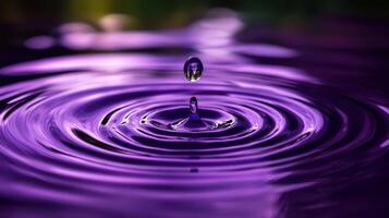 Mesmerizing purple water drop creating ripples in a calm liquid surface photo