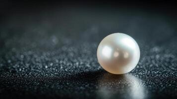 Elegant close-up of a shimmering pearl on textured surface capturing luxury and nature photo