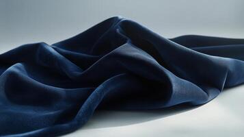 Elegant dark blue fabric with soft folds on light background concept photo