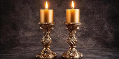 Elegant golden candlesticks with lit candles on ornate holders in dim light setting photo