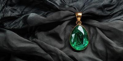 Elegant green gemstone pendant on luxurious dark fabric creating a rich aesthetic photo