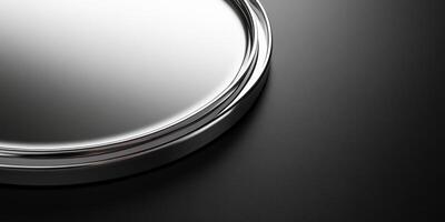 Close-up of metallic silver circular tray on black background for elegant concept photo