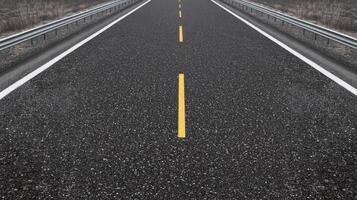 Empty asphalt highway with yellow road markings in rural landscape concept photo