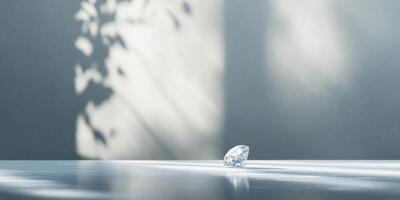 Sparkling diamond on reflective surface with leaf shadows and sunlight photo