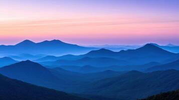 Stunning mountain range at sunrise with vibrant skies and misty valleys depicting tranquility and nature photo